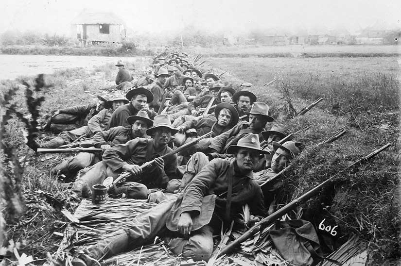 American soldiers of the 20th Kansas in trenches in the Philippines during the insurrection. Note the open baked beans can in the left foreground. Photo from the Library of Congress.